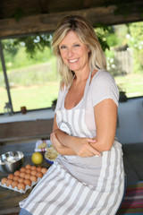 Portrait of beautiful mature woman cooking pastry