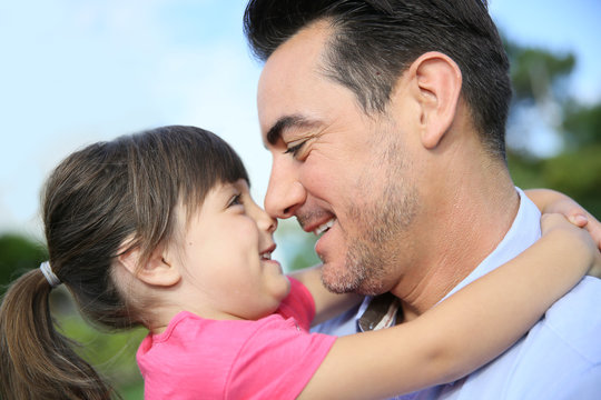 Portrait of little girl hugging her daddy