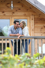 Couple standing in log cabin terrace