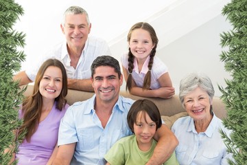 Composite image of smiling multigeneration family - Powered by Adobe