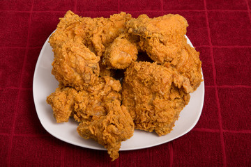 White Plate of Fried Chicken on Red Towel