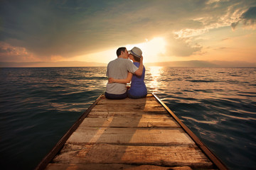 Young couple kissing at sunset
