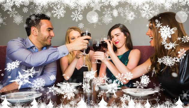 Composite image of happy friends drinking red wine in a bar
