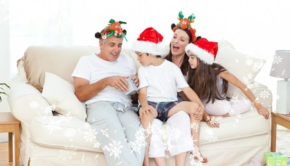 Obraz na płótnie Canvas Family on christmas day looking at their presents