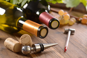 Stopper  with wine corks and bottles of wine on wooden