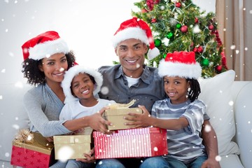 Smiling family sharing christmas presents