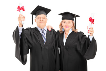 Mature couple celebrating their diplomas