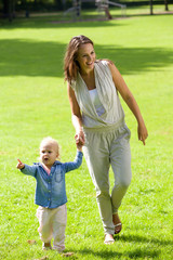 Fototapeta premium Mother and baby daughter walking outdoors