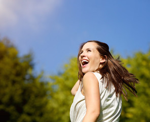 Carefree woman laughing outdoors