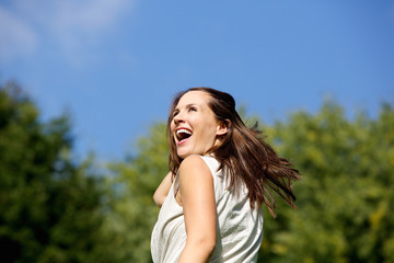 Attractive woman laughing outdoors