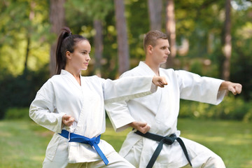 oman doing Gyaku-tsuki exercise with her instructor
