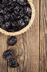 Prunes in wicker bowl closeup