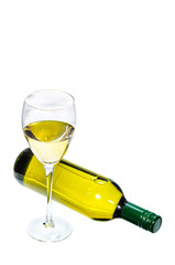 Glass of white wine with bottle