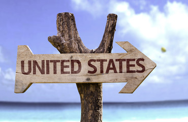 United States wooden sign with a beach on background