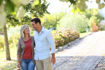 Couple walking hand in hand in park