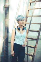 young beautiful short blue hair hipster woman with headphones mu