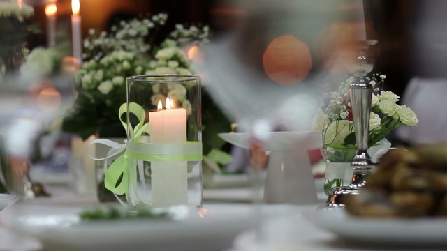 candle in a glass flask on festive table