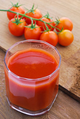 Tomato juice and  cherry tomatoes on the vine
