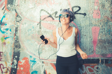 young beautiful short blue hair hipster woman with headphones mu - Powered by Adobe