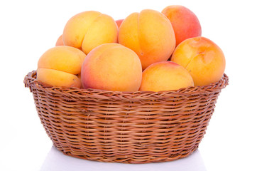 Fresh tasty apricots in a basket