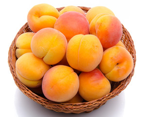 Fresh tasty apricots in a basket