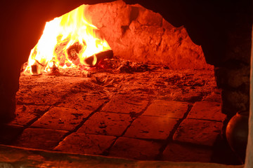 Burning wood in traditional hearth furnace