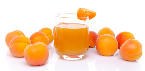 Glass of apricot juice surrounded with apricots