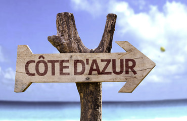 Cote d'Azur wooden sign with a beach on background