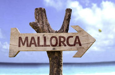 Mallorca wooden sign with a beach on background