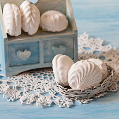 White marshmallows on the lace napkin (blue backgra