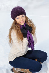 Girl Wearing Warm Winter Clothes And Hat Blowing Snow In Winte