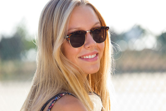 Young attractive woman with sunglasses on a summer day.