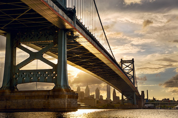 Ben Franklin Bridge above Philadelphia skyline at sunset, US