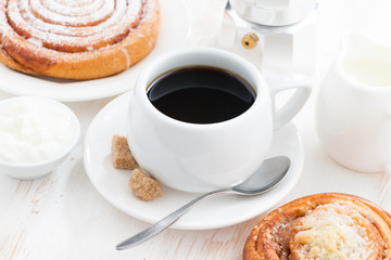 cup of black coffee and sweet bun for breakfast
