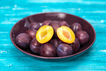 Fresh tasty plums in a bowl