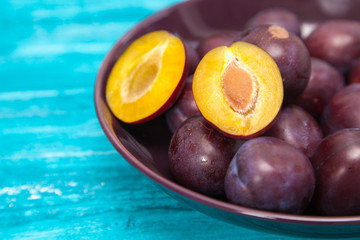 Fresh tasty plums in a bowl