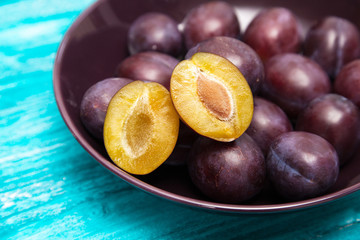 Fresh tasty plums in a bowl
