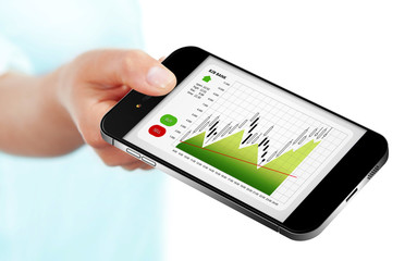 hand holding mobile phone with stock market chart isolated over