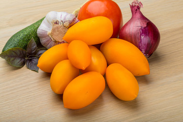 Yellow tomatoes on the board