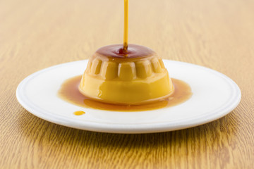 Creme caramel vanilla custard dessert or flan on white dish