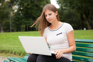 Woman using a laptop computer outdoors