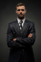 Waist-up portrait of handsome businessman with strong and confid