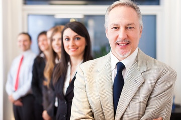 Businessman in front of his team