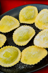 Raw ravioli on a dark background