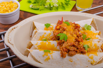 Baked meat tortilla with cheddar cheese