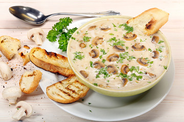 Mushroom soup with croutons on wooden background