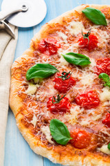 Pizza with cherry tomatoes and basil