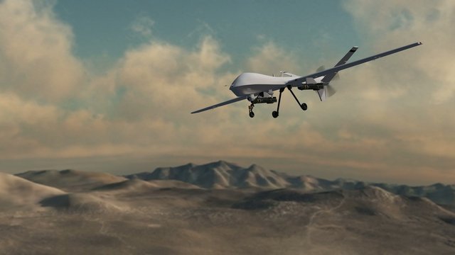 an armed drone in flight over desert - close up