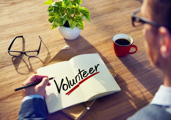 Man with a Note and a Single Word Volunteer