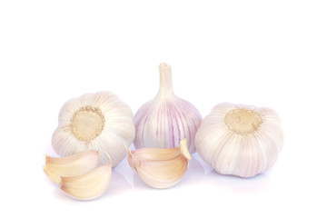 Garlic bulb and cloves on white background